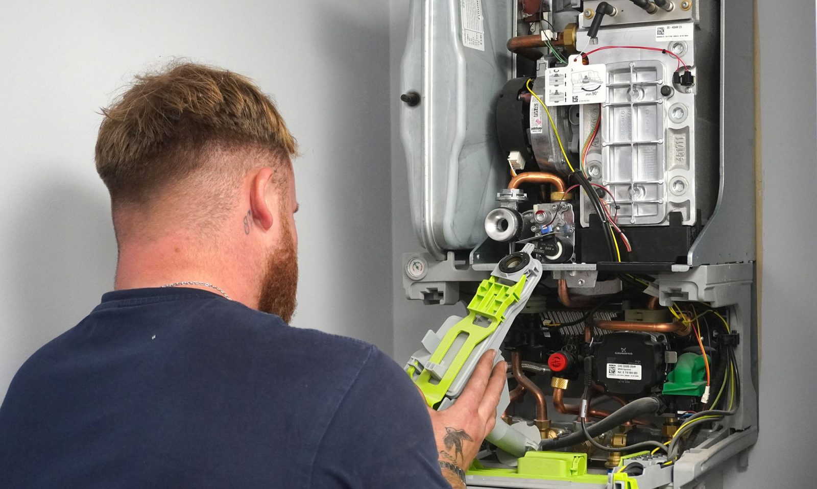 Gas engineer working on boiler